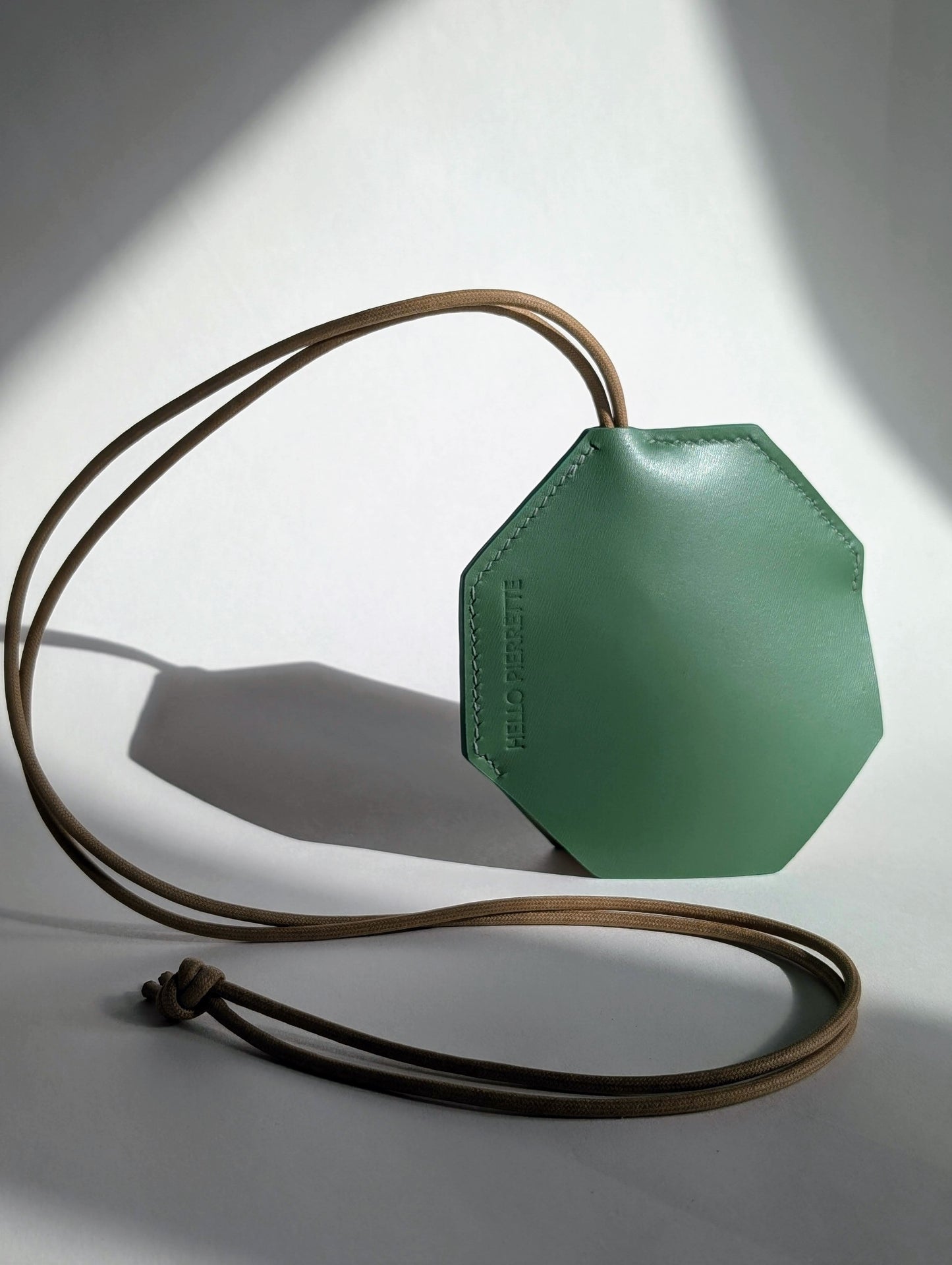 Elegant octagonal leather key pouch in green, showcasing quality craftsmanship and durability, perfect for stylish key storage.